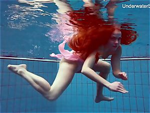 ginger-haired Simonna demonstrating her body underwater